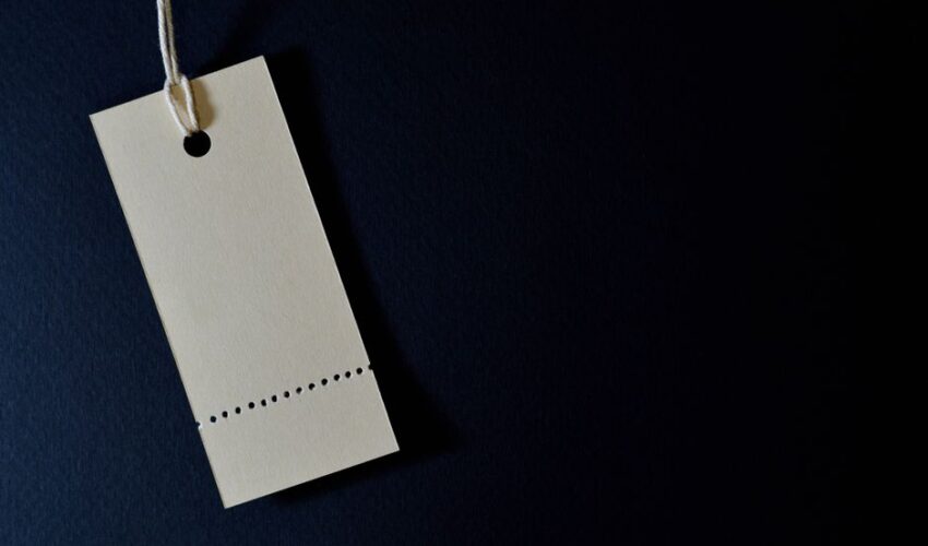 Elegant minimalist card with a string, ideal for labeling or pricing against a black background.