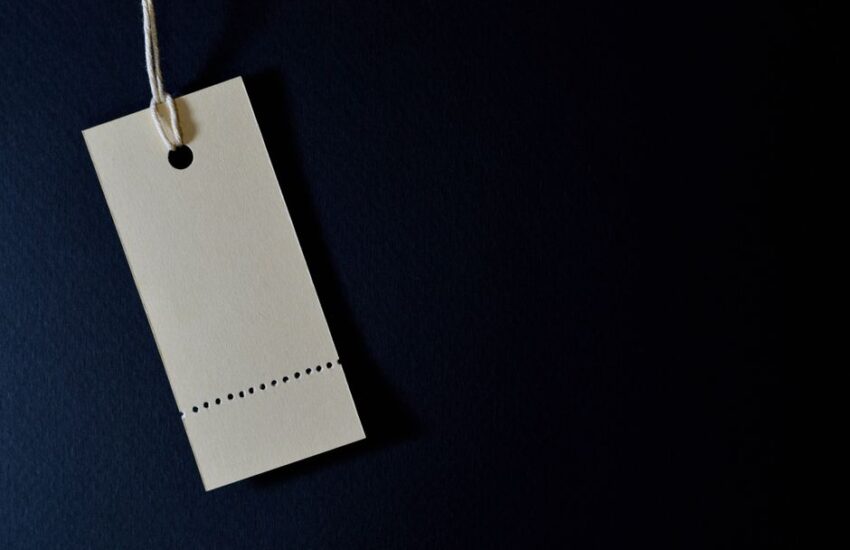 Elegant minimalist card with a string, ideal for labeling or pricing against a black background.