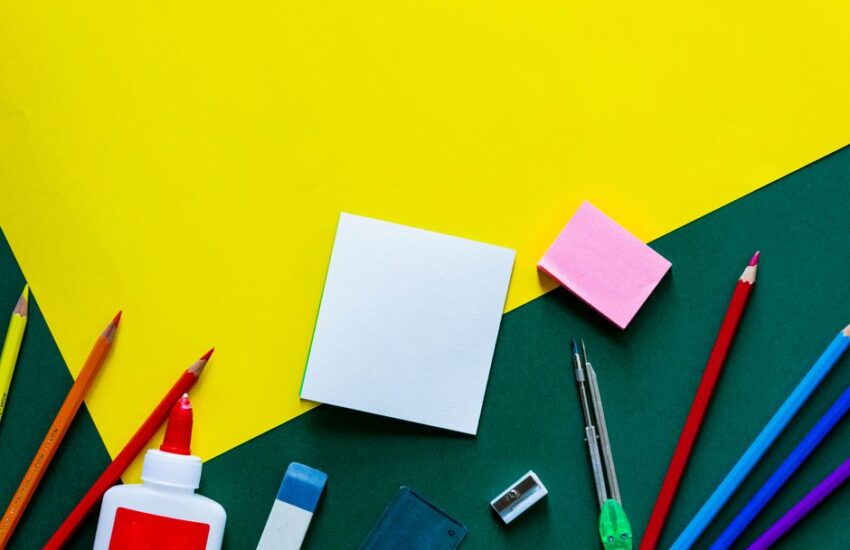 A vibrant flat lay of various school supplies on a yellow and green geometric background.