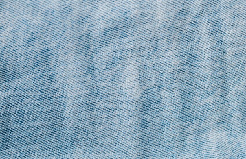 Detailed close-up of light blue denim fabric showcasing texture and weave pattern.